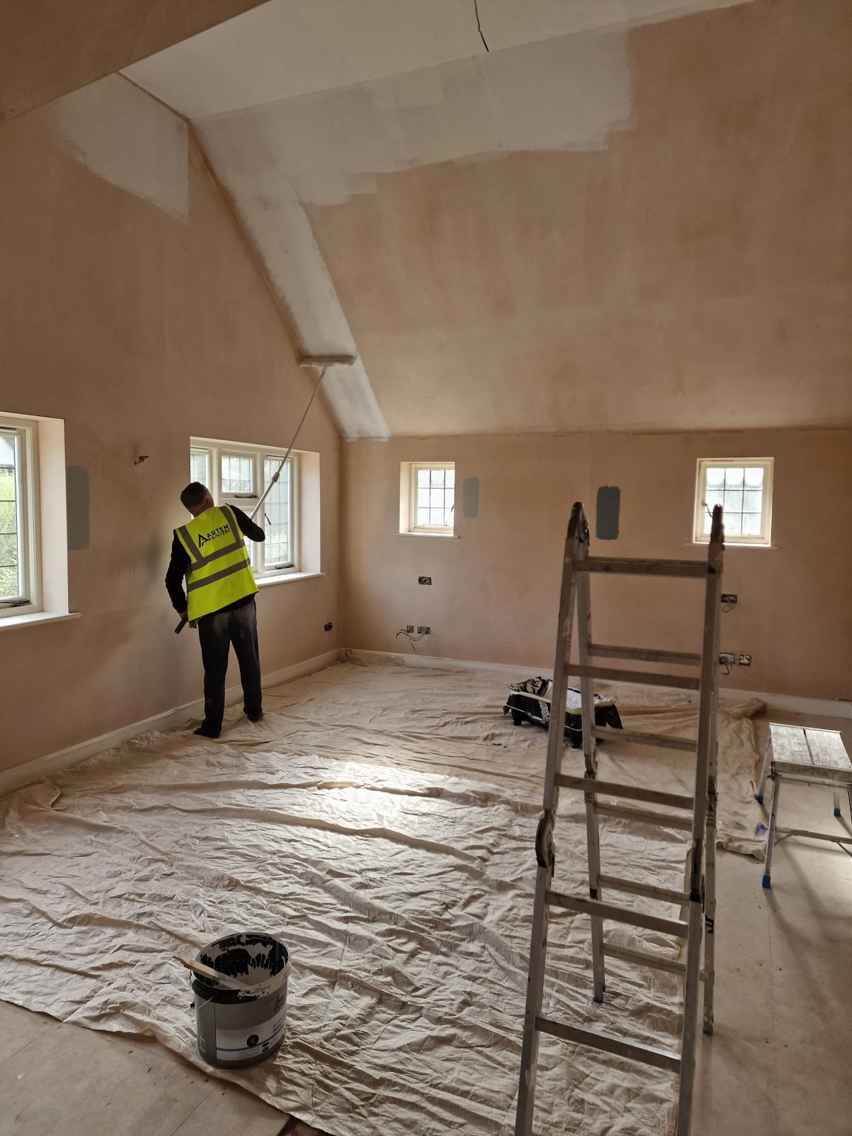 Interior room before painting — tired, marked walls